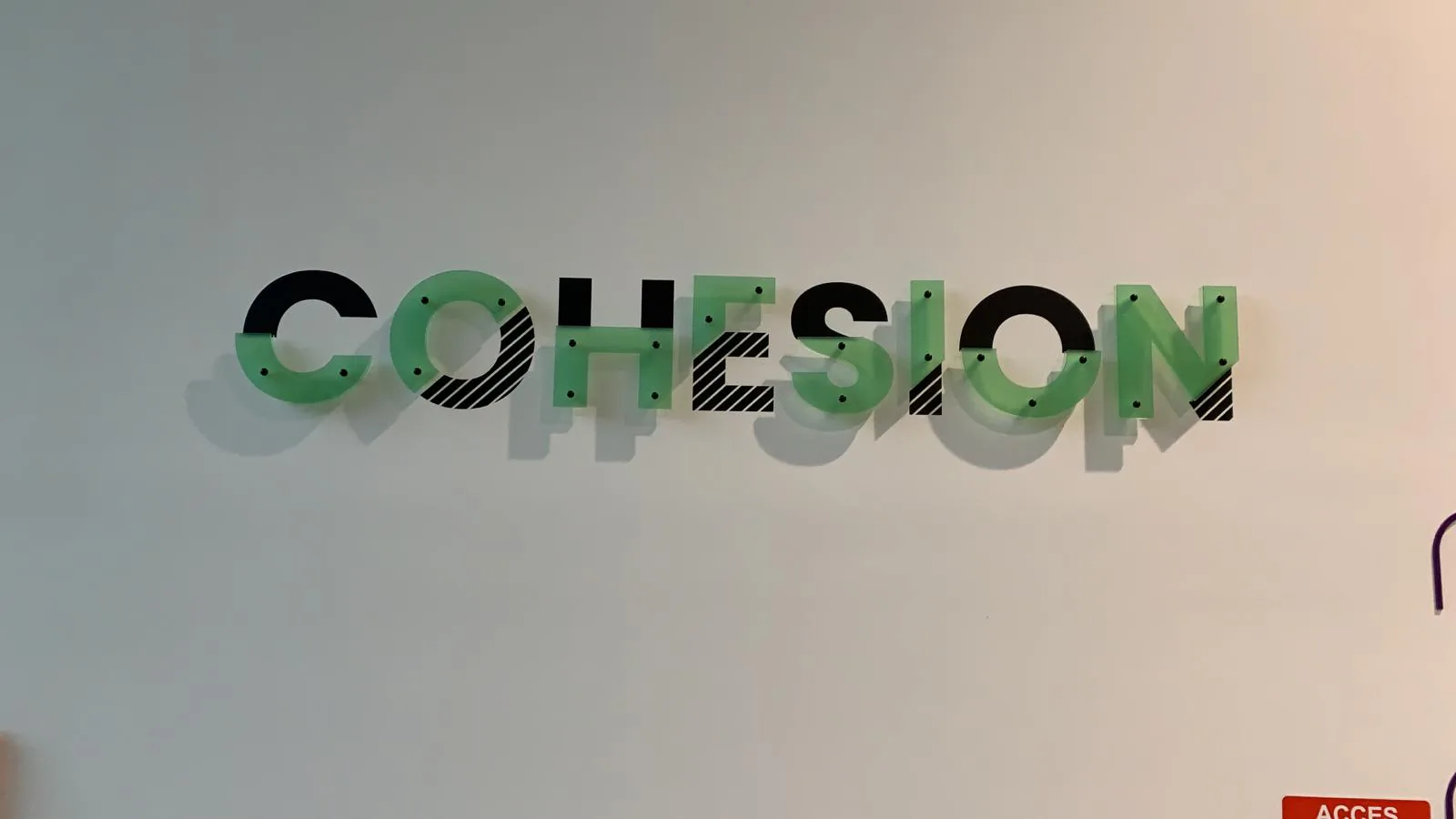 Mot Cohésion en lettres plexiglass vert et noir, valeur d'entreprise Payplug